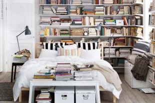 Book shelves make a perfect headboard in this cozy bibliophile's