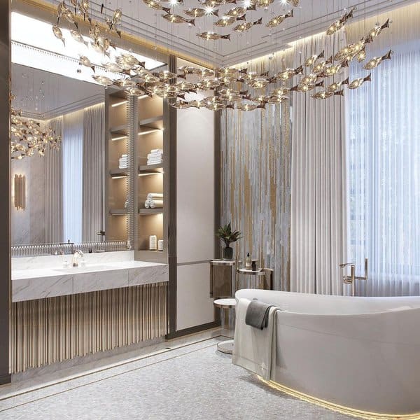 Luxurious bathroom with chandelier, marble vanity, and freestanding bathtub.