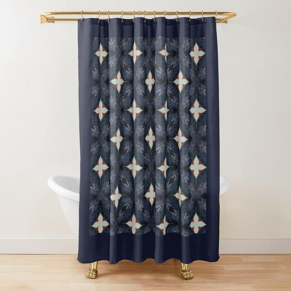 Dark geometric patterned shower curtain in a white bathroom with a clawfoot tub and gold rod.