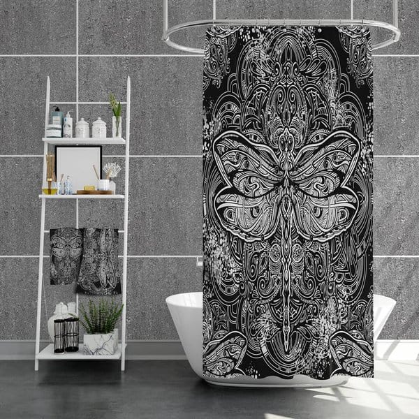 Black and white dragonfly patterned shower curtain in a gray-tiled modern bathroom with a shelf unit.