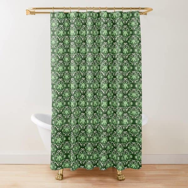 Green patterned shower curtain with gold shower rod in a bathroom with a white clawfoot tub.