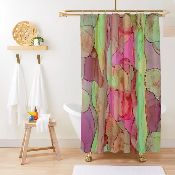 Colorful abstract shower curtain in a bright bathroom with white towels and a clawfoot tub.