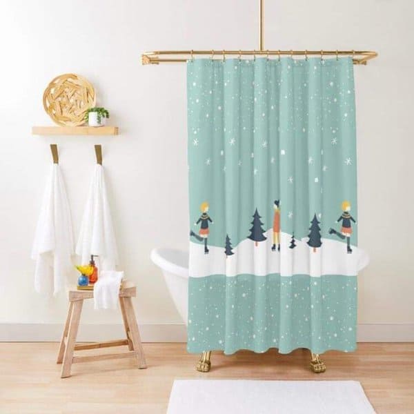 Winter-themed shower curtain with skaters and snow in a cozy bathroom with white towels.