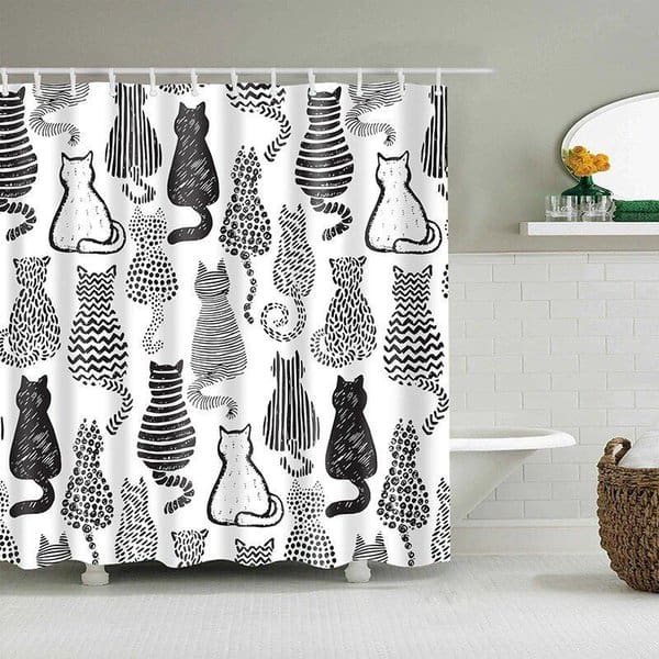 Shower curtain with black and white cat illustrations in a minimalist bathroom.