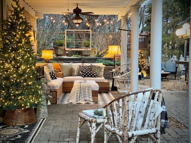 Charming outdoor lounge with cozy seating, warm lighting, festive decorations, and rustic elements, creating a welcoming and serene atmosphere for all seasons