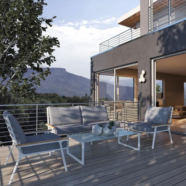 Modern patio with chairs, table, and mountain view; contemporary house exterior