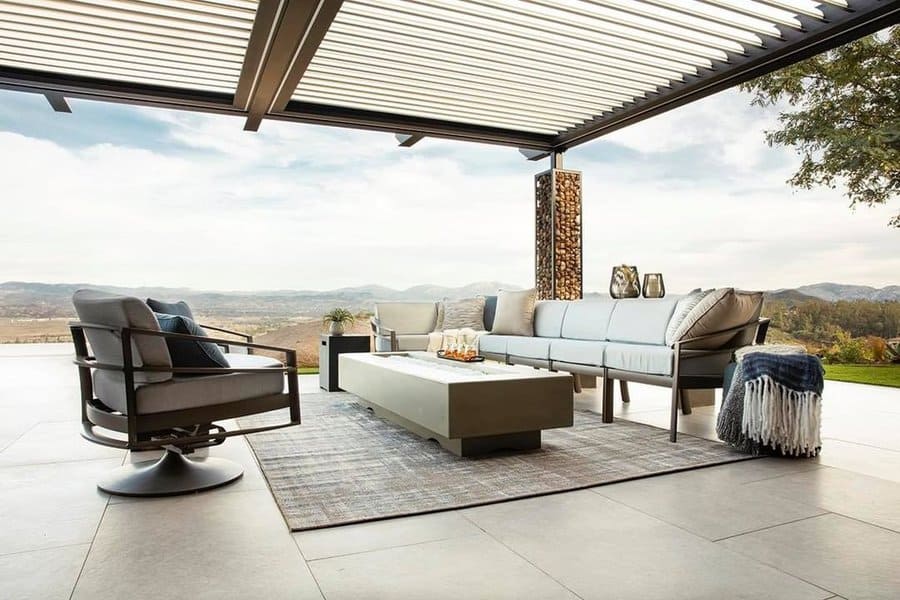 Elegant outdoor seating under a modern pergola, offering panoramic views and sleek, neutral furnishings